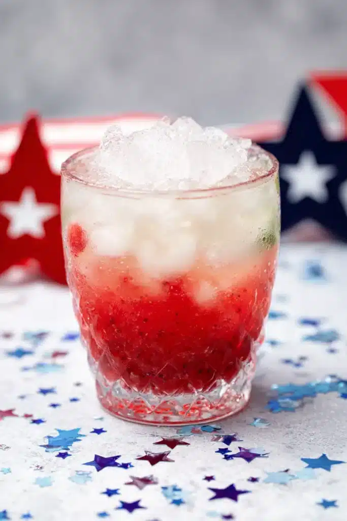 4th Of July Mojito with crushed ice and raspberry layer in festive cocktail glass