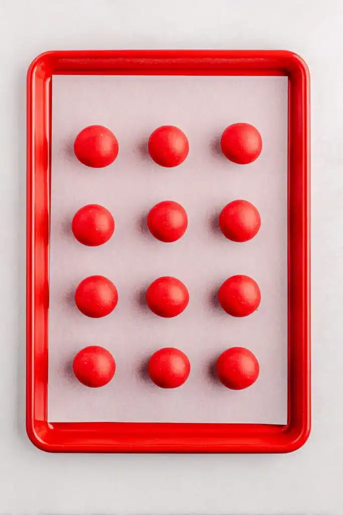 4th Of July Oreo Balls 4 4th Of July Oreo Balls coated in red candy melts on a tray