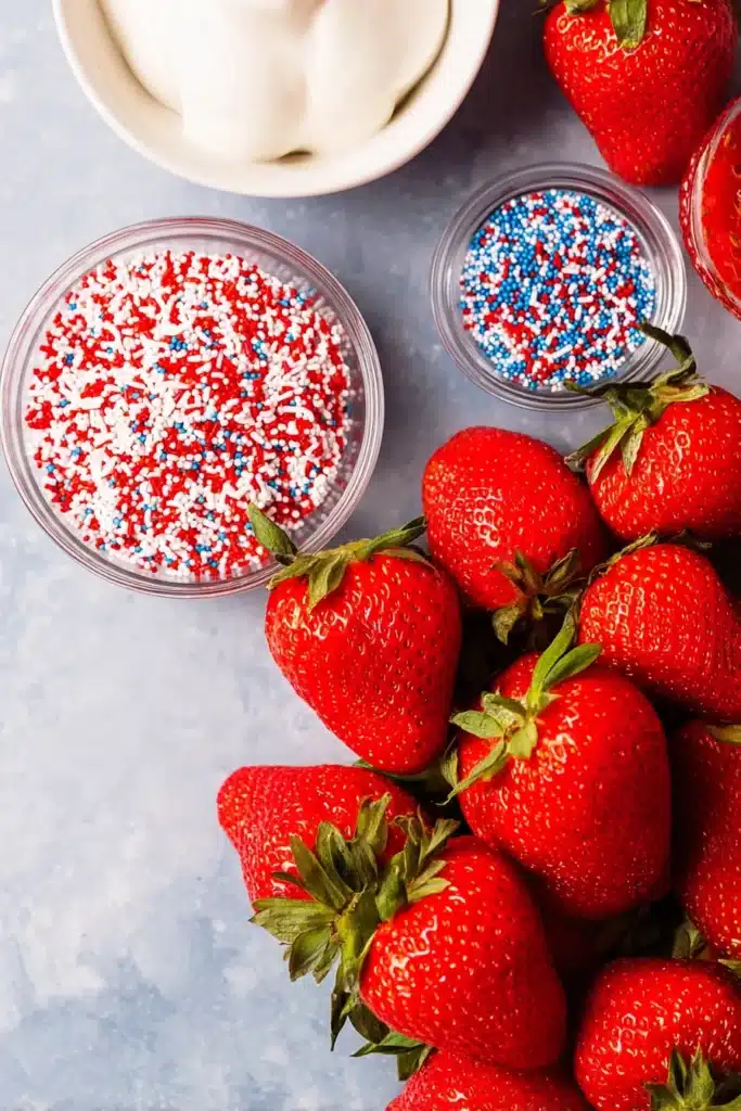 Fresh ingredients for 4th of July Strawberries with white chocolate and patriotic sprinkles