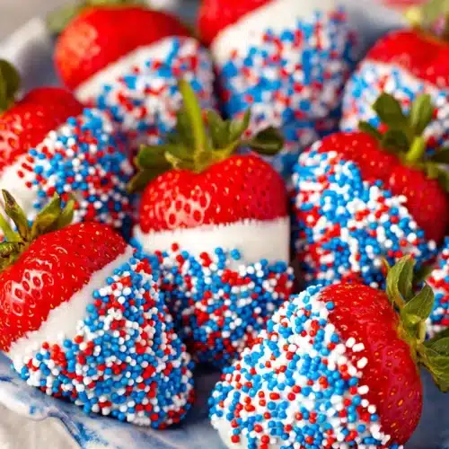 4th of July strawberries dipped in white chocolate with red white and blue sprinkles