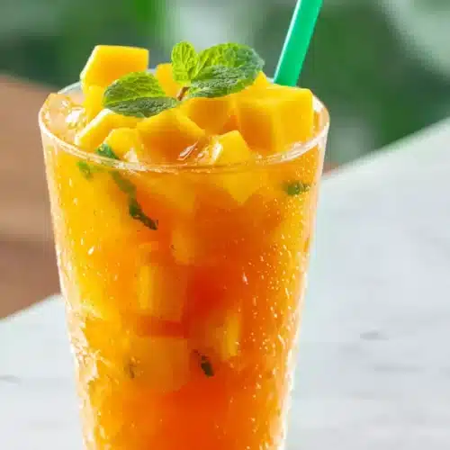 Homemade Mango Iced Tea That Tastes Fresh and Tropical 4 Homemade Mango Iced Tea served over ice with mango and mint