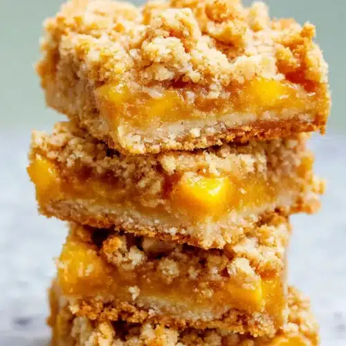 Mango Oatmeal Crumble Bars stacked with buttery oat crumble and juicy mango filling