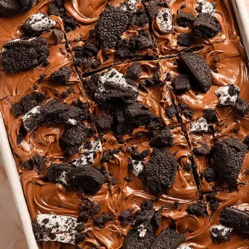 Oreo Dirt Cake Recipe 6 Oreo dirt cake with creamy chocolate topping and crushed Oreo cookies in a baking dish