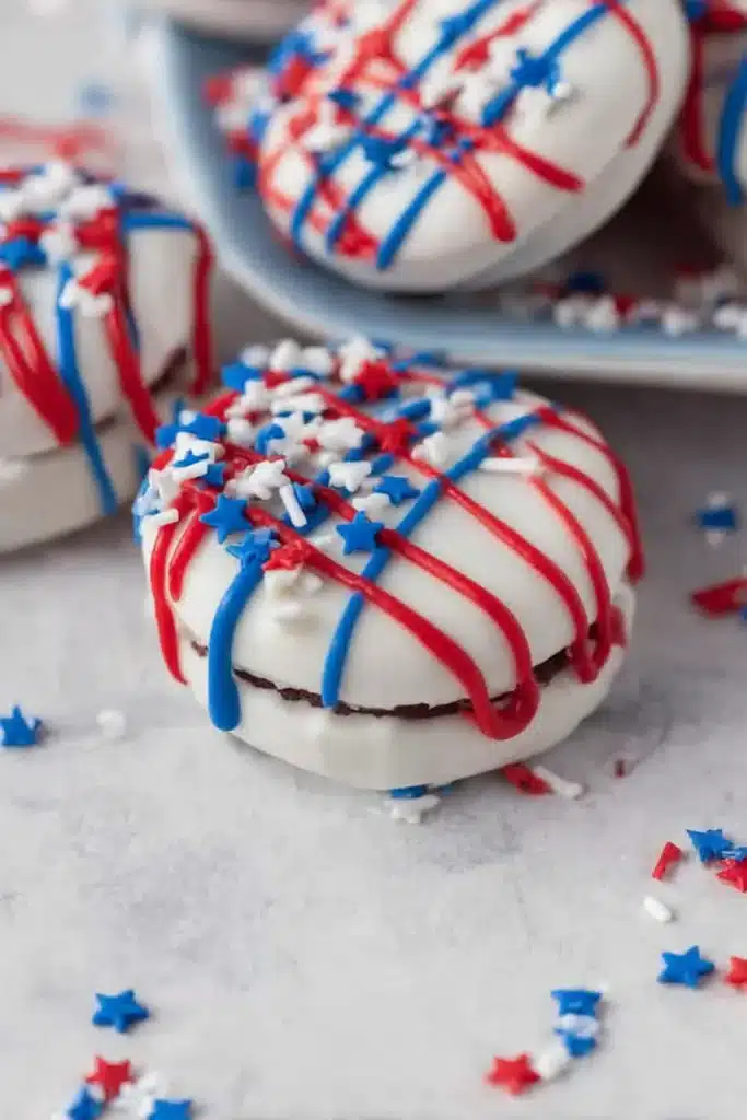 Oreos Dipped in White Chocolate with red and blue drizzle