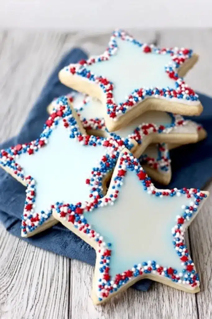 Decorated Star Cookies with blue royal icing and patriotic sprinkle borders on a serving platter