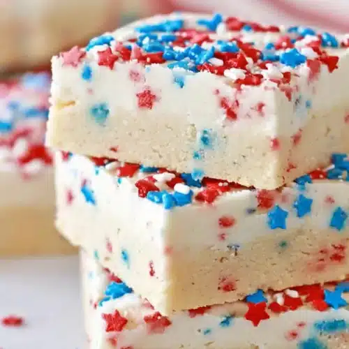 Patriotic Sugar Cookie Bars for the Perfect 4th of July Dessert 6 Patriotic sugar cookie bars with creamy frosting and red white blue sprinkles