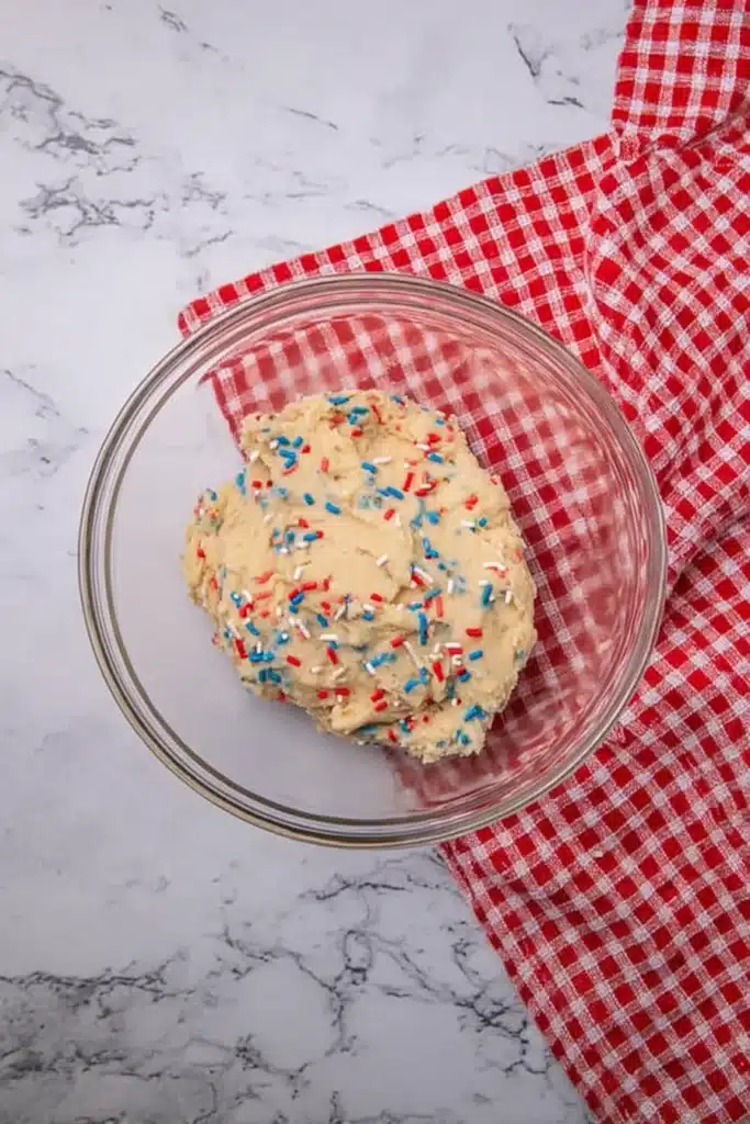 Patriotic Sugar Cookie Bars for the Perfect 4th of July Dessert 2 Patriotic sugar cookie bars dough with red white and blue sprinkles