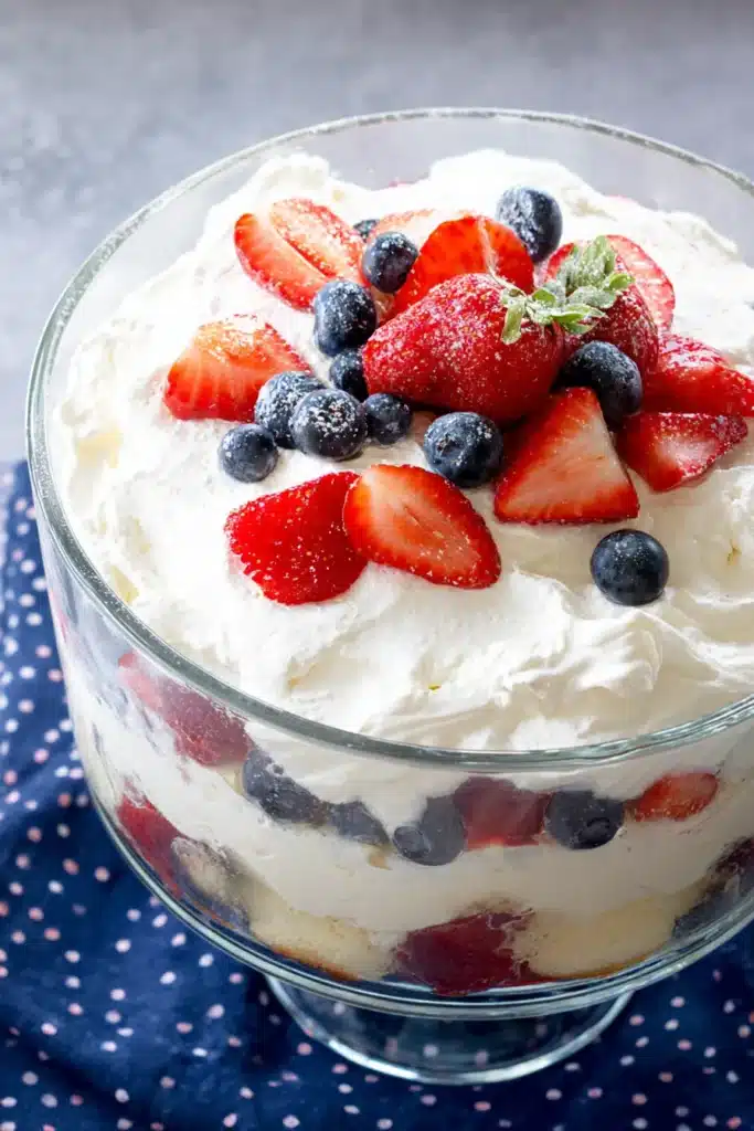 Patriotic Trifle Dessert topped with whipped cream strawberries and blueberries