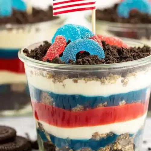 Red White and Blue Dirt Cups with Oreo crumbs and patriotic gummy candy topping