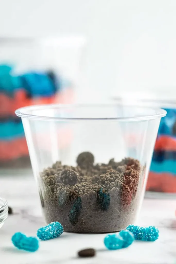 Red White and Blue Dirt Cups with Oreo crumb base in clear dessert cup
