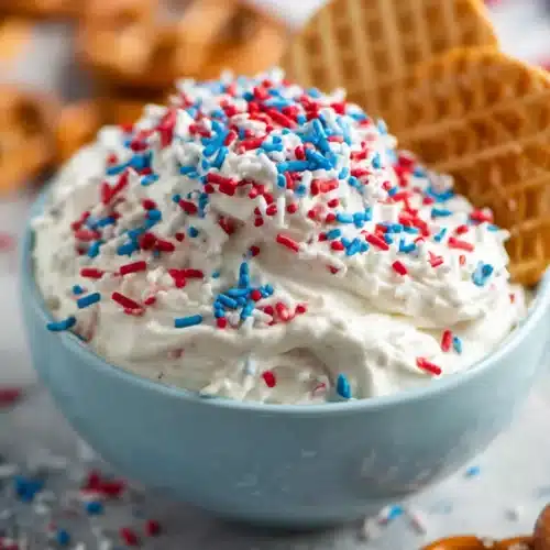 Red White and Blue Funfetti Dip 5 Red White and Blue Funfetti Dip topped with patriotic sprinkles and waffle cookies