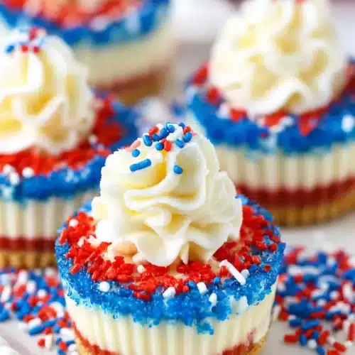 Red White and Blue Mini Cheesecakes with whipped cream and patriotic sprinkles