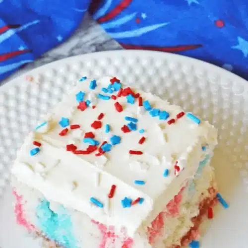 Red White And Blue Poke Cake with holes filled with gelatin in baking dish