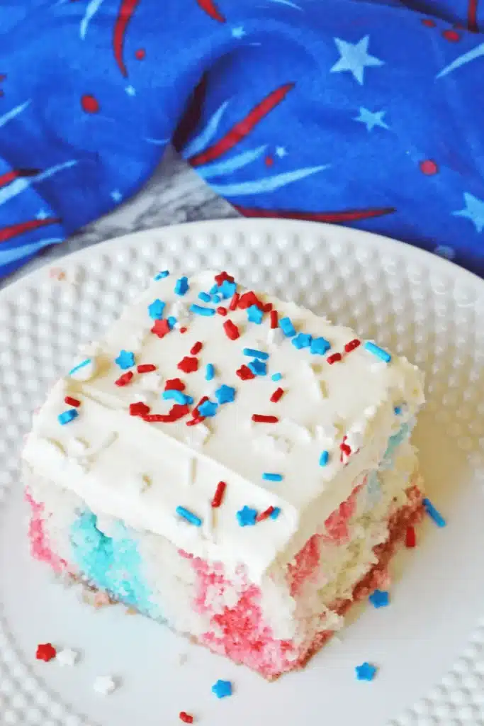 Red White And Blue Poke Cake with holes filled with gelatin in baking dish