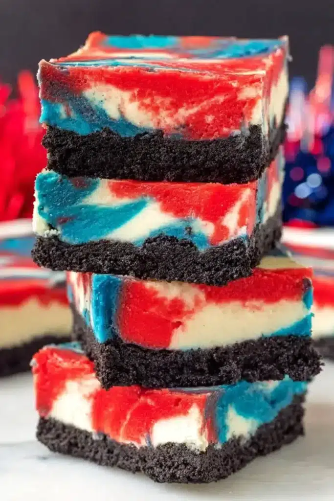 Red White and Blue Cheesecake Bars 4 Stacked Red White and Blue Cheesecake Bars with Oreo crust