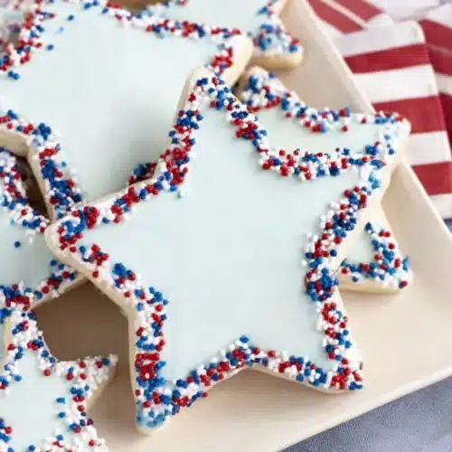Star Cookies cut into shapes on a parchment lined baking sheet