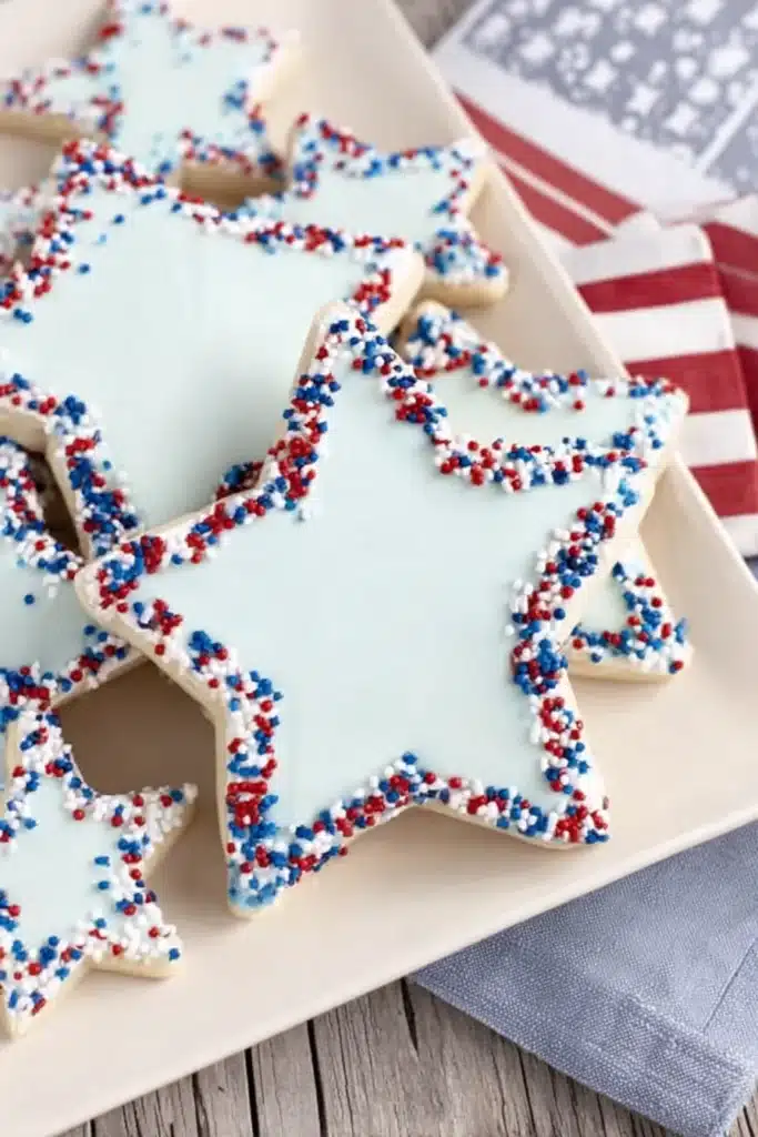 Star Cookies cut into shapes on a parchment lined baking sheet