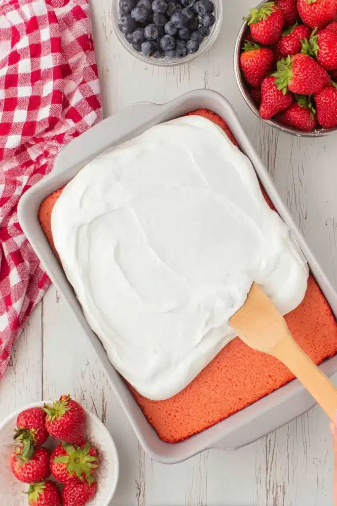 Strawberry Jello Flag Cake covered with whipped topping