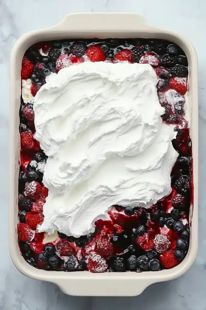 Summer Berry Poke Cake with berry filling and cheesecake topping