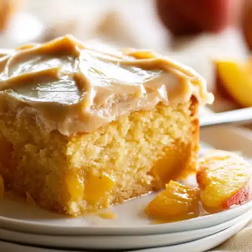Brown Sugar Peach Cake 5 Brown Sugar Peach Cake slice with caramel frosting and juicy peach pieces
