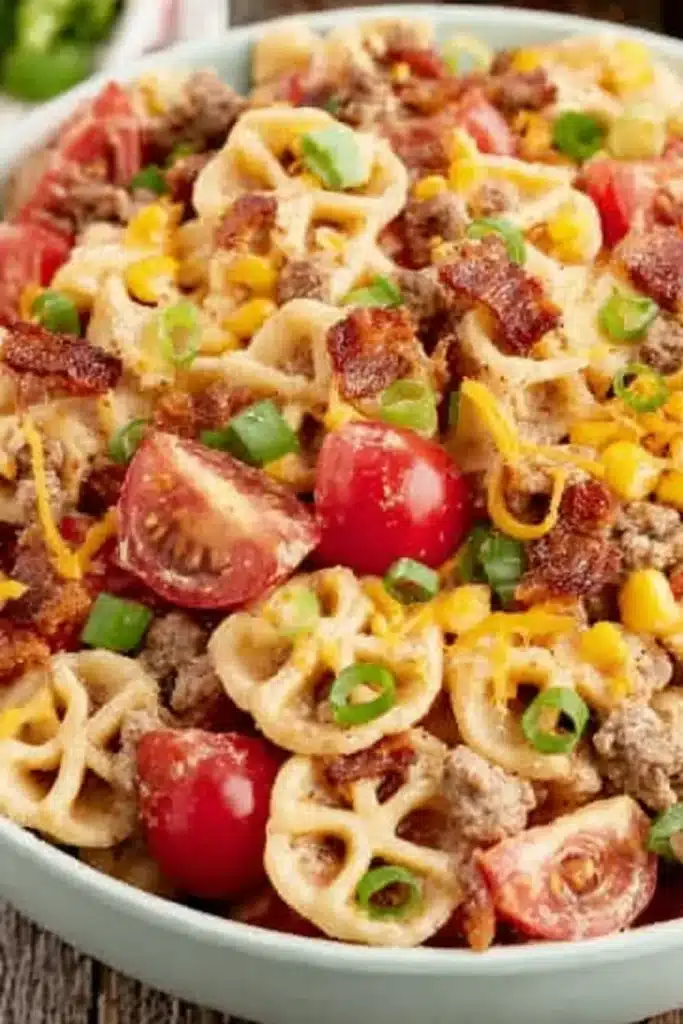 Cowboy Pasta Salad 2 Cowboy Pasta Salad with bacon, beef, corn, cheddar cheese, and creamy barbecue dressing