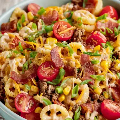 Cowboy Pasta Salad 3 Cowboy Pasta Salad with bacon, beef, cheddar cheese, corn, and creamy barbecue dressing