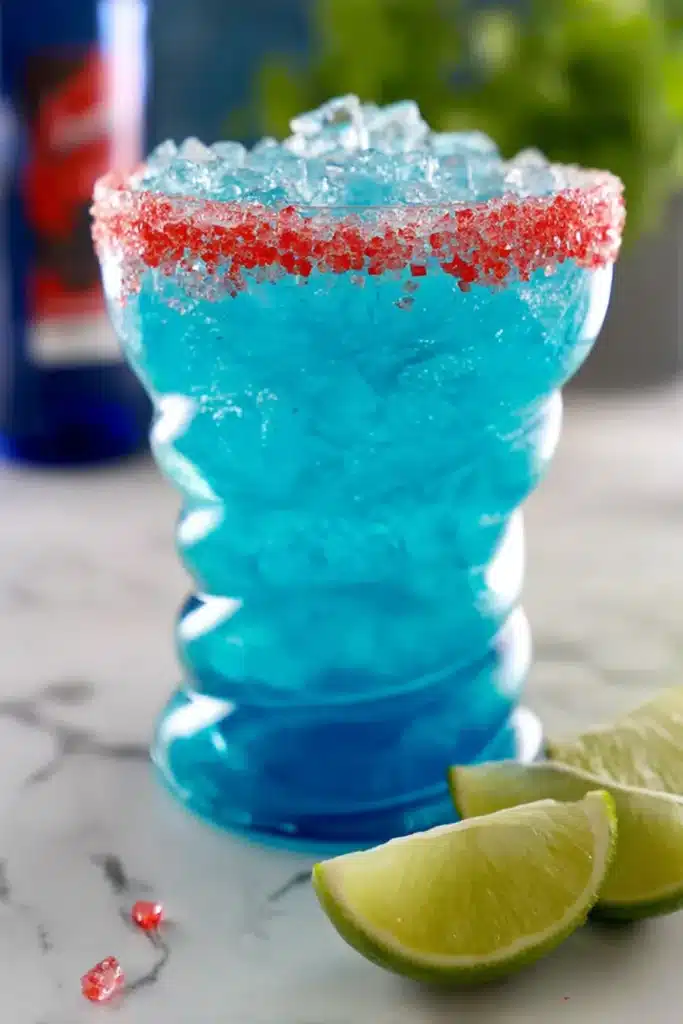 Firecracker Margarita with blue curaçao, crushed ice, and red candy rim