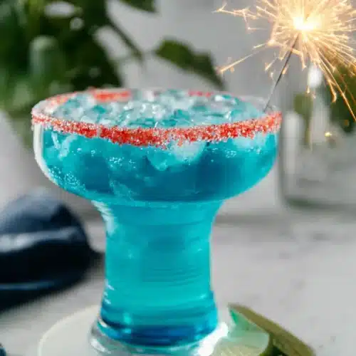 Firecracker Margarita with red candy rim and sparkler for Fourth of July