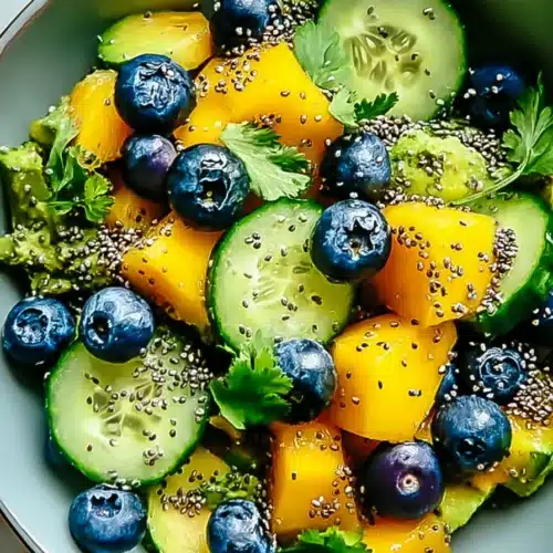 Juicy Mango Cucumber Salad with blueberries, avocado, and fresh herbs