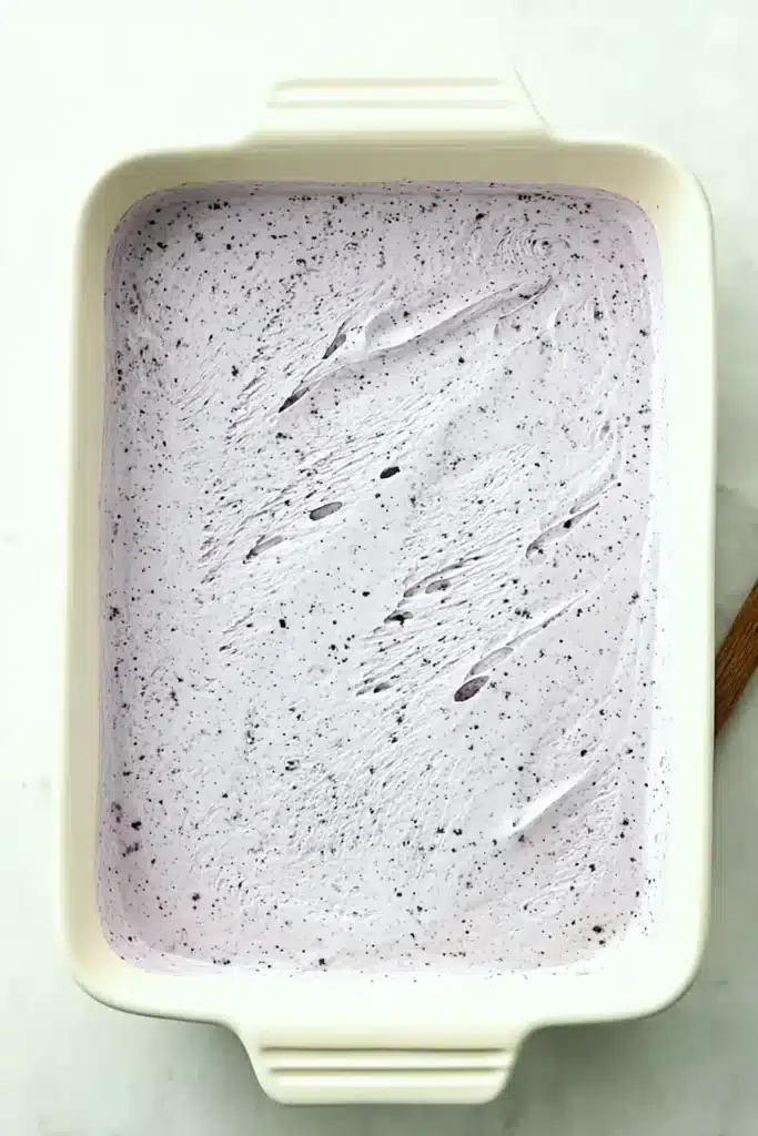 Lemon Blueberry Lasagna lemon pudding layer spread in baking dish