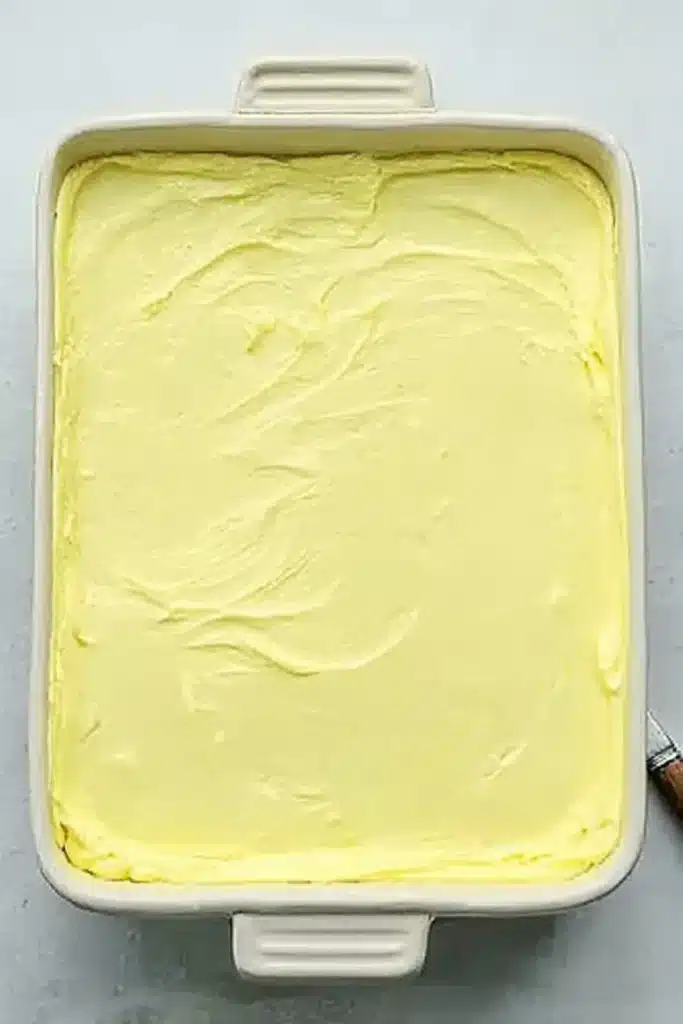 Lemon Blueberry Lasagna whipped topping layer spread over lemon pudding