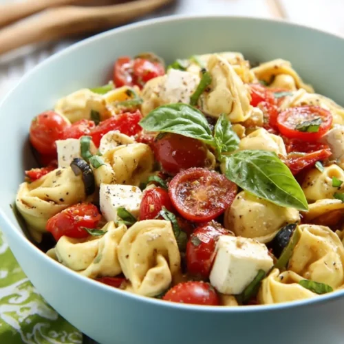 Parmesan Tortellini Salad with mozzarella, tomatoes, olives, basil, and tangy Parmesan dressing