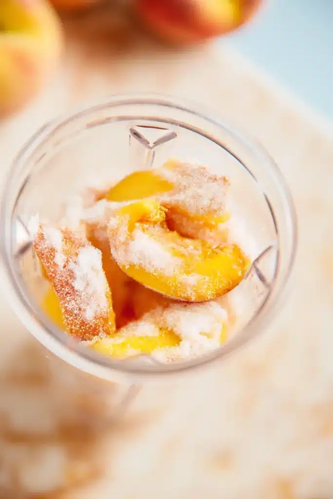 Peach Sorbet 2 Peach Sorbet ingredients with peaches and sugar in a blender