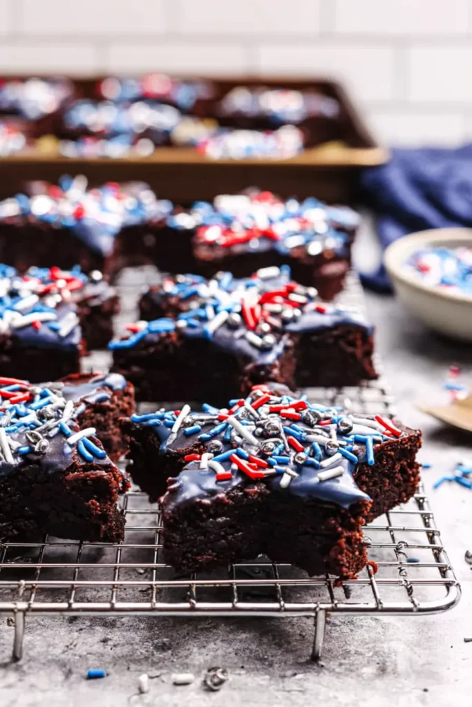 Star-Spangled Brownies 3 Star-Spangled Brownies with blue drizzle and patriotic sprinkles on a rack