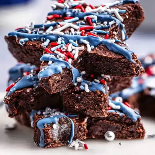 Star-Spangled Brownies 4 Star-Spangled Brownies with blue candy drizzle and patriotic sprinkles