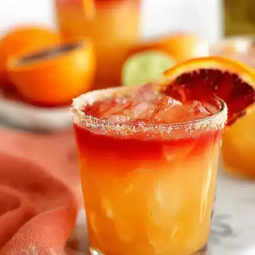 Tequila Sunrise Margarita 3 Tequila Sunrise Margarita with orange garnish and layered grenadine sunrise effect