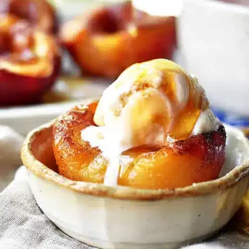 Cinnamon sugar baked peaches with vanilla ice cream and caramel drizzle