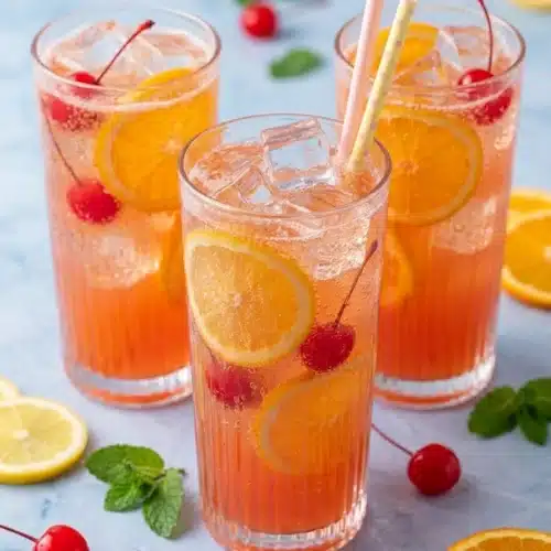 Shirley Temple Party Punch Recipe That Everyone Will Love 3 Shirley Temple Party Punch with orange slices and cherries in glasses