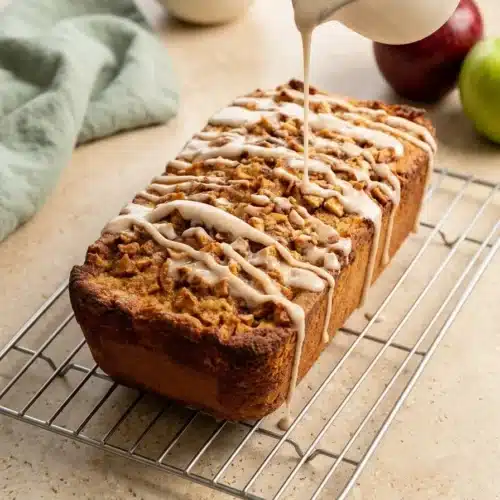 Cinnamon Apple Bread: Easy, Moist, and Perfect for Thanksgiving 5 Cinnamon Apple Bread drizzled with sweet cinnamon glaze on a cooling rack